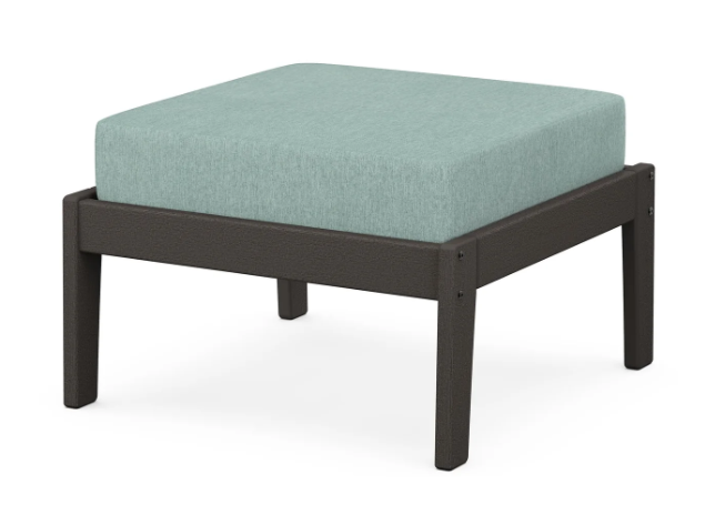 A light blue cushioned deep seating ottoman with a vintage coffee frame, made from all-weather materials suitable for outdoor use.