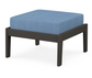 A blue cushioned deep seating ottoman with a vintage coffee frame, made from all-weather materials suitable for outdoor use.