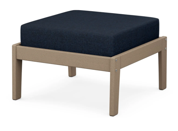 A navy cushioned deep seating ottoman with a vintage sahara frame, made from all-weather materials suitable for outdoor use.