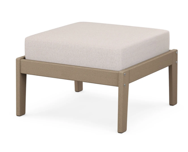 A cream cushioned deep seating ottoman with a vintage sahara frame, made from all-weather materials suitable for outdoor use.