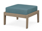A teal cushioned deep seating ottoman with a vintage sahara frame, made from all-weather materials suitable for outdoor use.