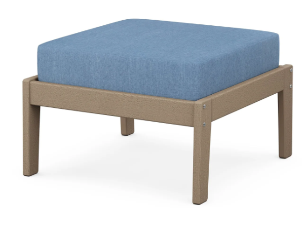 A blue cushioned deep seating ottoman with a vintage sahara frame, made from all-weather materials suitable for outdoor use.
