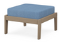 A blue cushioned deep seating ottoman with a vintage sahara frame, made from all-weather materials suitable for outdoor use.