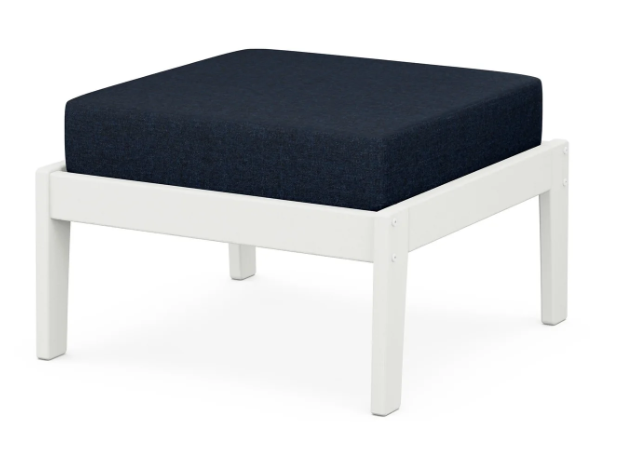 A navy cushioned deep seating ottoman with a vintage white frame, made from all-weather materials suitable for outdoor use.