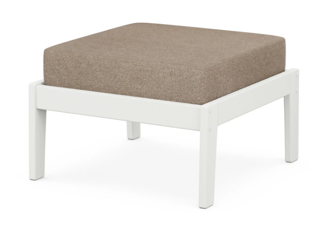 A beige cushioned deep seating ottoman with a vintage white frame, made from all-weather materials suitable for outdoor use.