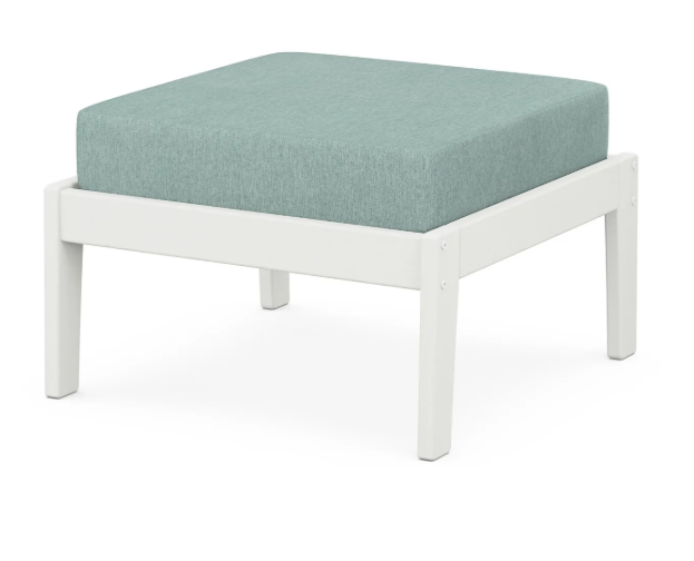 A light blue cushioned deep seating ottoman with a vintage white frame, made from all-weather materials suitable for outdoor use.