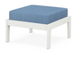A blue cushioned deep seating ottoman with a vintage white frame, made from all-weather materials suitable for outdoor use.