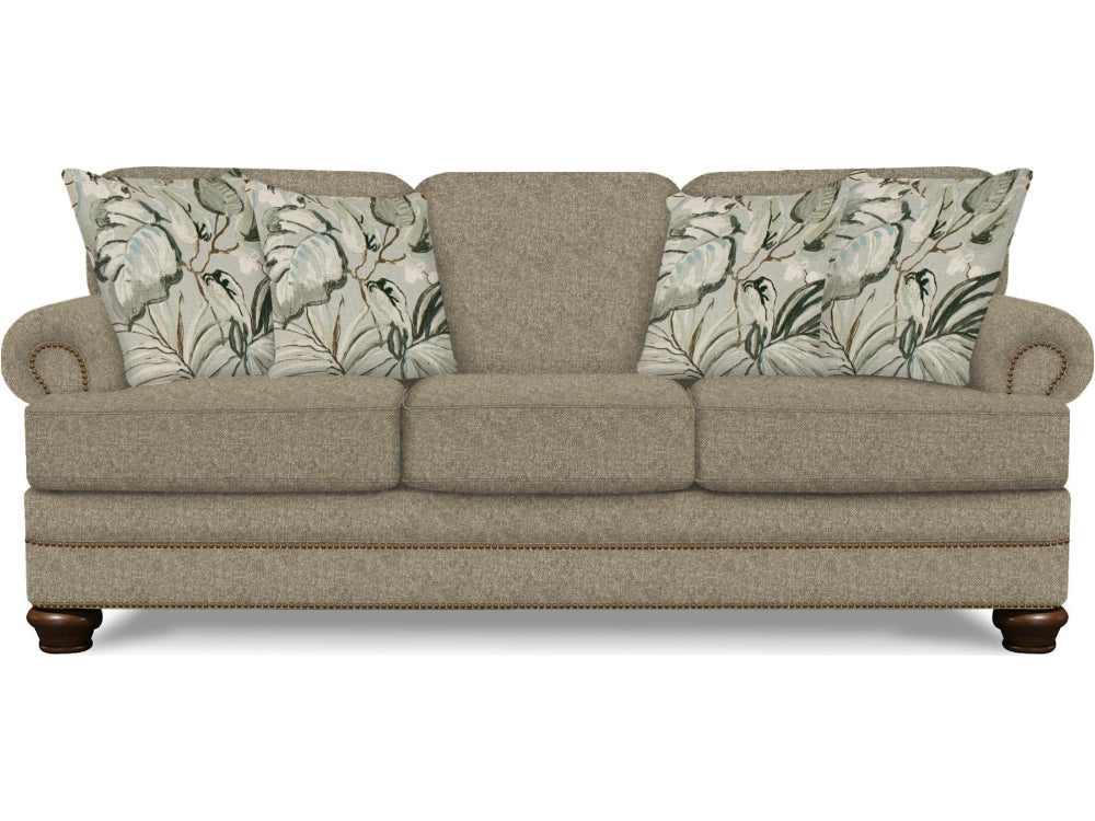 Beige sofa with floral-patterned cushions on a white background
