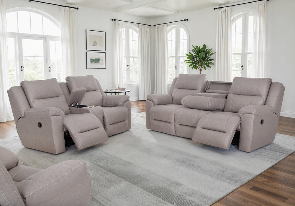 Gray reclining sofa set in a living room with large windows and a rug.