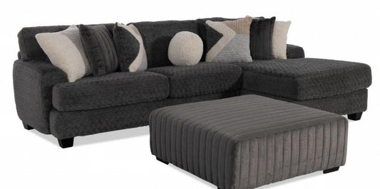 Gray sectional sofa with patterned cushions and matching ottoman on a white background