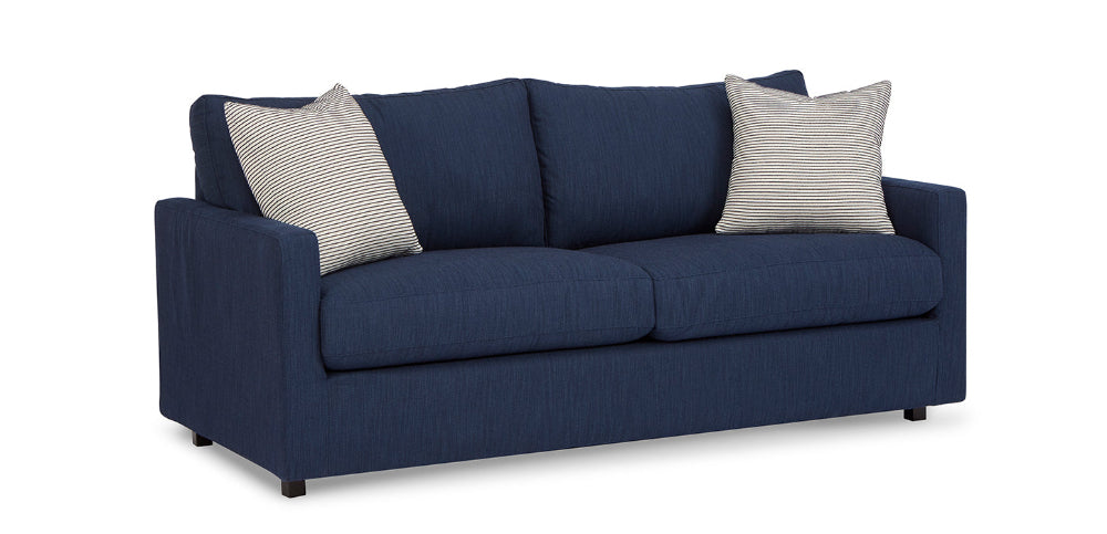 Blue sofa with striped cushions on a white background