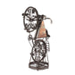 Decorative metal sculpture of a person on a bicycle with gears and a triangular panel.