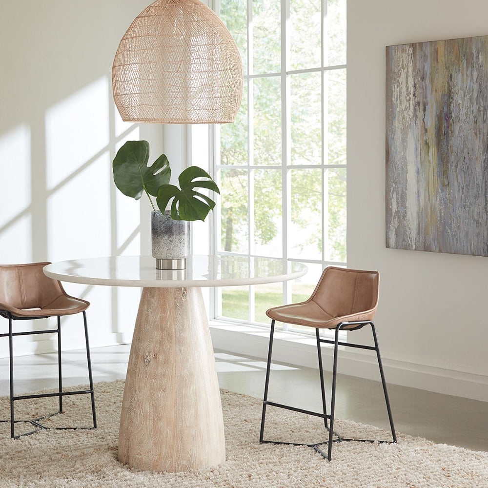 Modern dining room with a round table and chairs near large windows.