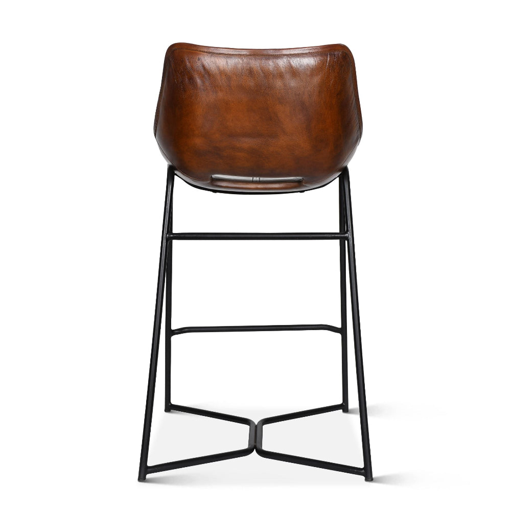 Brown leather bar stool with black metal legs on a white background