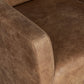 Close-up of a brown leather sofa with visible texture and stitching.