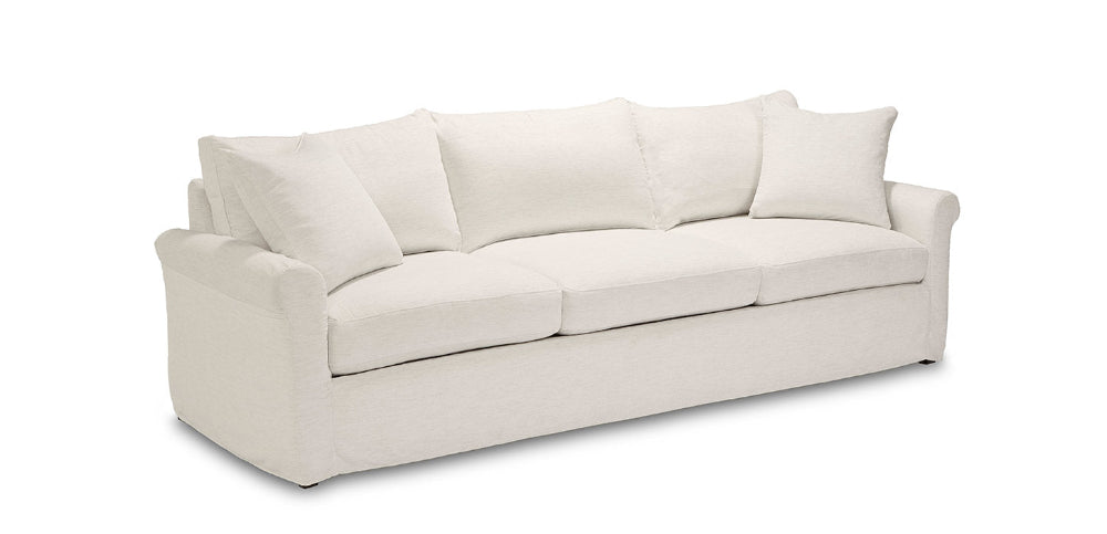 Beige sofa with three cushions on a white background