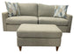 Beige sofa with two patterned cushions with matching ottoman on a white background