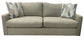 Beige sofa with patterned cushions on a white background