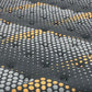Close-up of a textured wall panel with circular patterns 