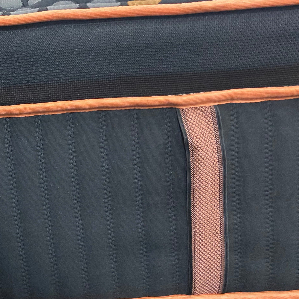 Black and orange textured mat on a display with a patterned floor background