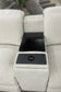 Intricate armrest with cup holders and control panel on a beige sectional