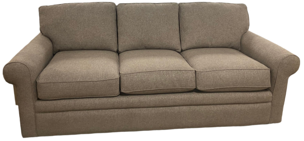 A brown Collins sofa with a casual style, featuring three seat cushions a textured fabric cover.