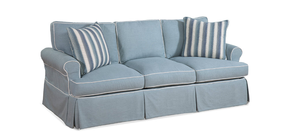 Light blue sofa with striped cushions on a white background