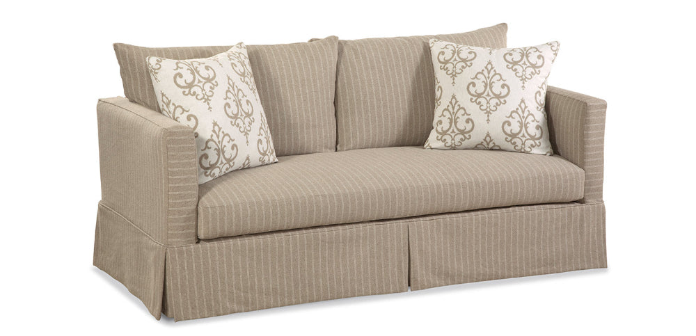 Beige striped sofa with patterned cushions on a white background
