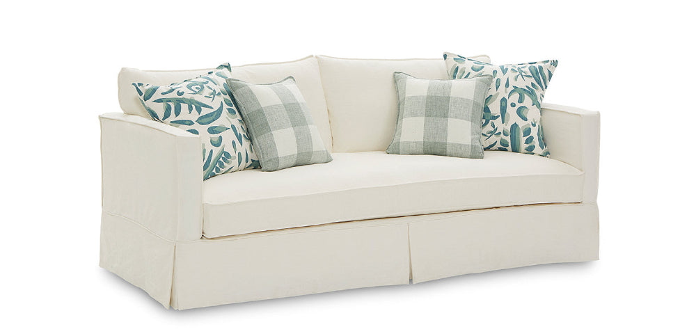 White sofa with patterned cushions on a white background