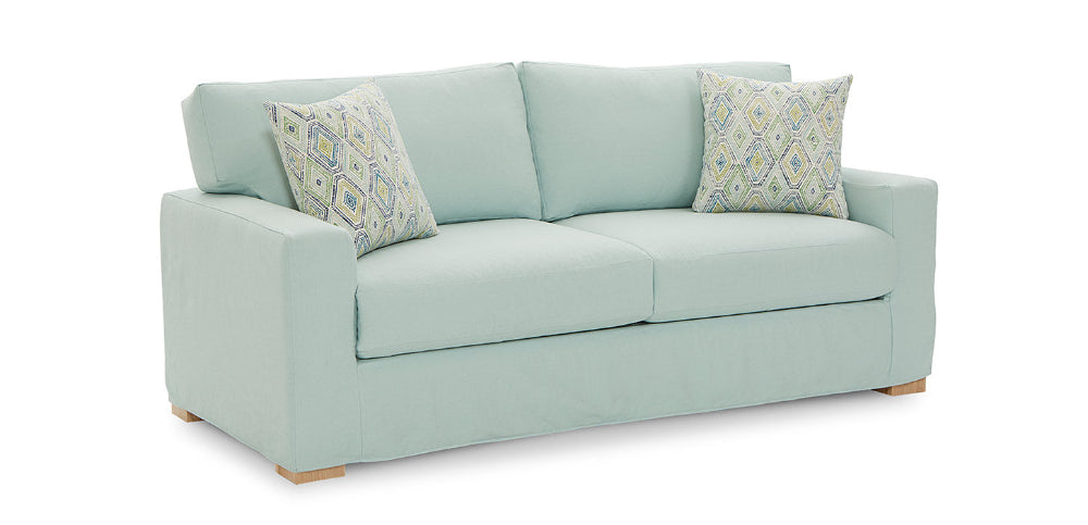 Light blue sofa with patterned cushions on a white background