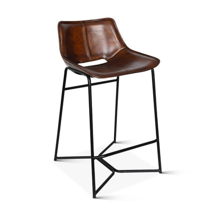 A hand washed chestnut brown leather upholstered counter chair with black metal legs and a cutout in the backrest.