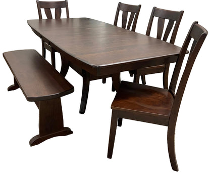 A Covina dining set with a wood finish including a rectangular dining table with two leaves, a trestle bench, and four side chairs 