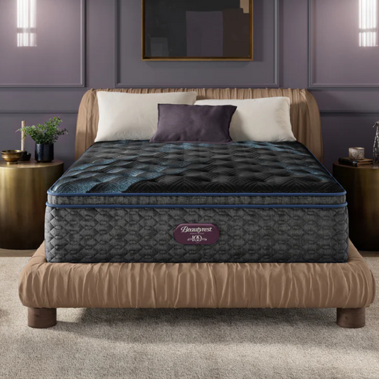 Gray mattress on a bed in a bedroom setting with a brand logo visible