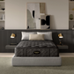 Black mattress on a gray bed frame in a modern bedroom setting with abstract art and lamps.