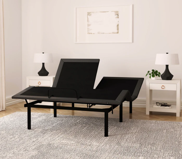 Black adjustable bed in a room with white walls and lamps.