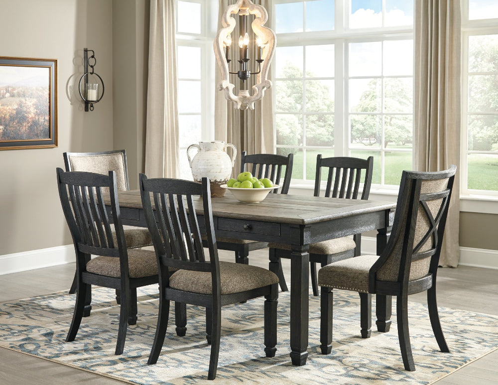Dining room with a wooden table and chairs in a well-lit room.