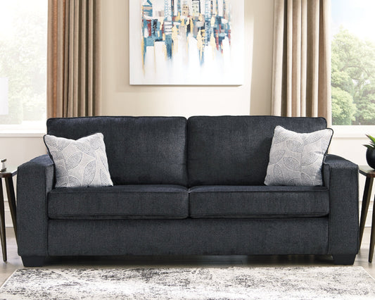 Gray sofa with decorative pillows in a living room setting