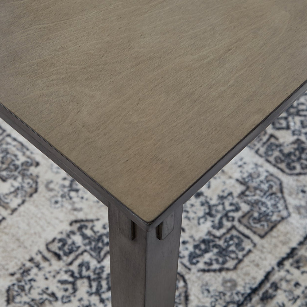 Wooden table corner on a patterned rug