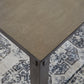 Wooden table corner on a patterned rug