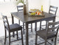 Dining table set with chairs and a decorative tray on a patterned rug.