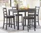 Dining room with a gray dining table and four matching chairs on a rug.