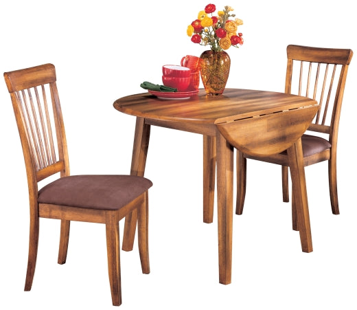 Wooden dining table with two chairs and a vase of flowers on a white background