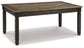 Wooden dining table with dark finish on a white background