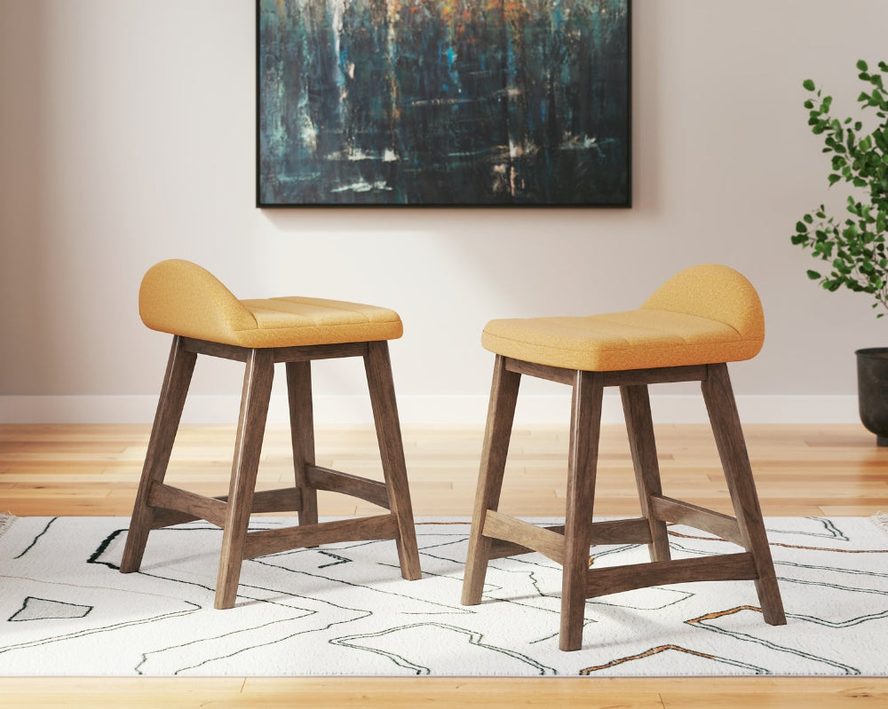 2 yellow upholstered stools on a white rug with an abstract painting on the wall
