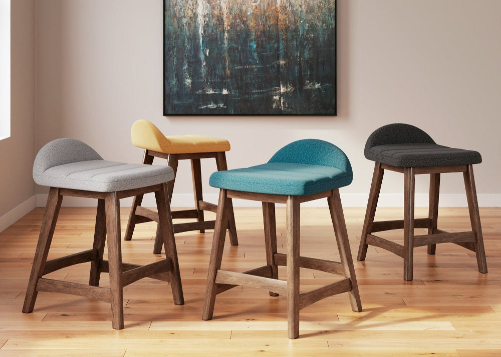gray, yellow, teal, and dark gray stool with an abstract painting on the wall