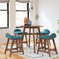 4 teal upholstered stools around a brown round counter height table
