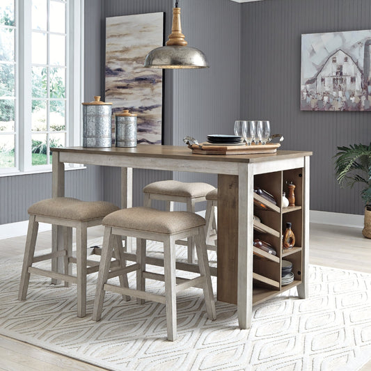 Dining area with a wooden bar table and stools in a room with gray walls and large windows.