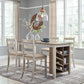 Dining room with wooden table and chairs, rug, and decorative elements.