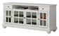 White entertainment console with glass doors on a white background