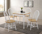 Dining table set with four chairs in a room with large windows and framed pictures on the wall.